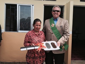 PCL Director Fred Garmon presents a ceremonial key to a home to an Andong resident.