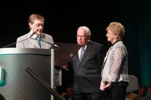 Immediate past general overseer, Mark Williams (left) presents a resolution of appreciation to O. Wayne Chambers while his wife, Carolyn, looks on (click to enlarge photo)