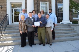 Smoky Mountain Children’s Home Senior Administrative Team display the certificate from Charity Navigator: Front Row: Tammy Mauldin, Dr. Walt Mauldin, Dr. Wade Horton, Shane Smith. Back Row: Dr. Coleman Peacock, Linda Loyd, Beverly Beard, Marvin Amos (click photo to enlarge).